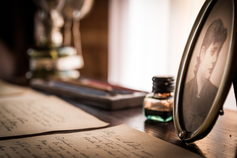 Letters, a photo of a woman and an ink bottle on a desk