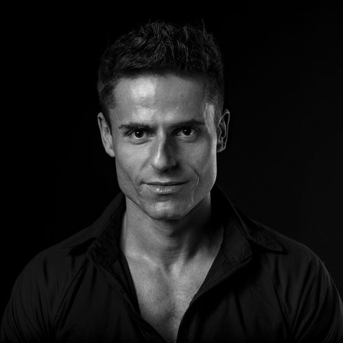 A black and white photo of Bartosz Kałużny, a brunette looking directly at the camera