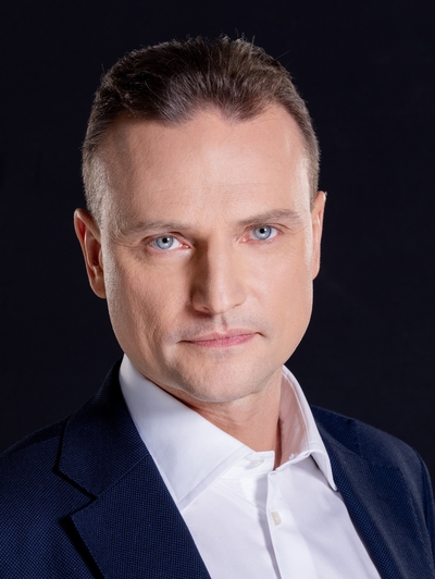 The middle-aged male speaker in a suit