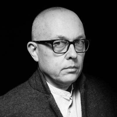 A black and white photo of a man wearing glasses
