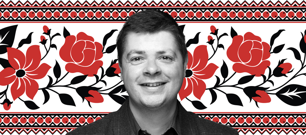 Dr Tomasz Lachowski on a white background with a pattern of red flowers with black leaves