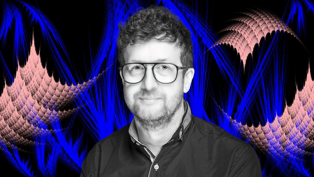 Prof. Dariusz Wardowski on a colorful background with fractals ​