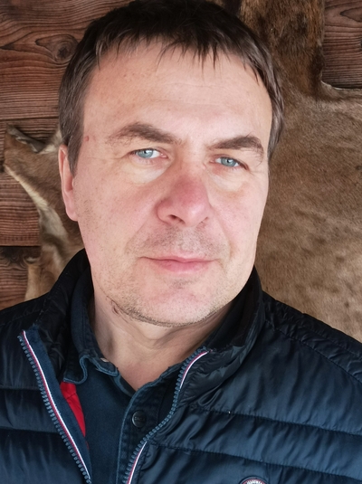 The middle aged male speaker wearing a down jacket
