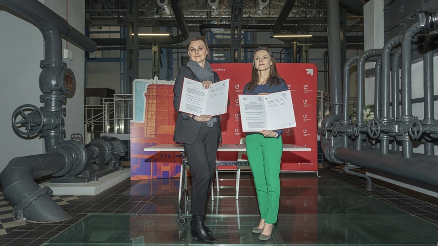 Prof. Kurczewska and Magdalena Kosiada-Sylburska with copies of the cooperation agreement in a post-industrial interior